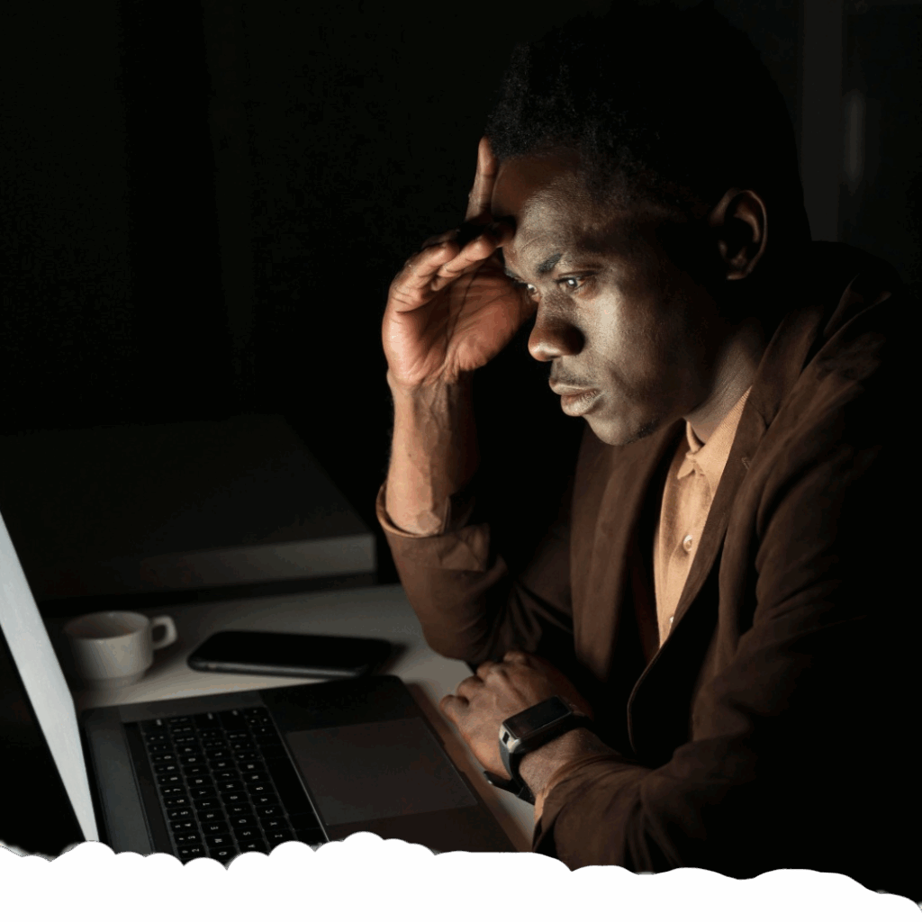 Person reflecting while scrolling through laptop images, showing signs of Digital Amnesia